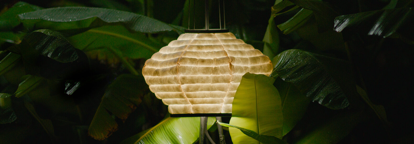 an-intricate-lamp-that-is-made-out-of-banana-paper